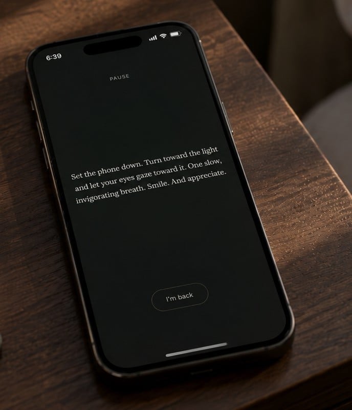 Primed's Pause screen on a phone at a bedside table in morning light